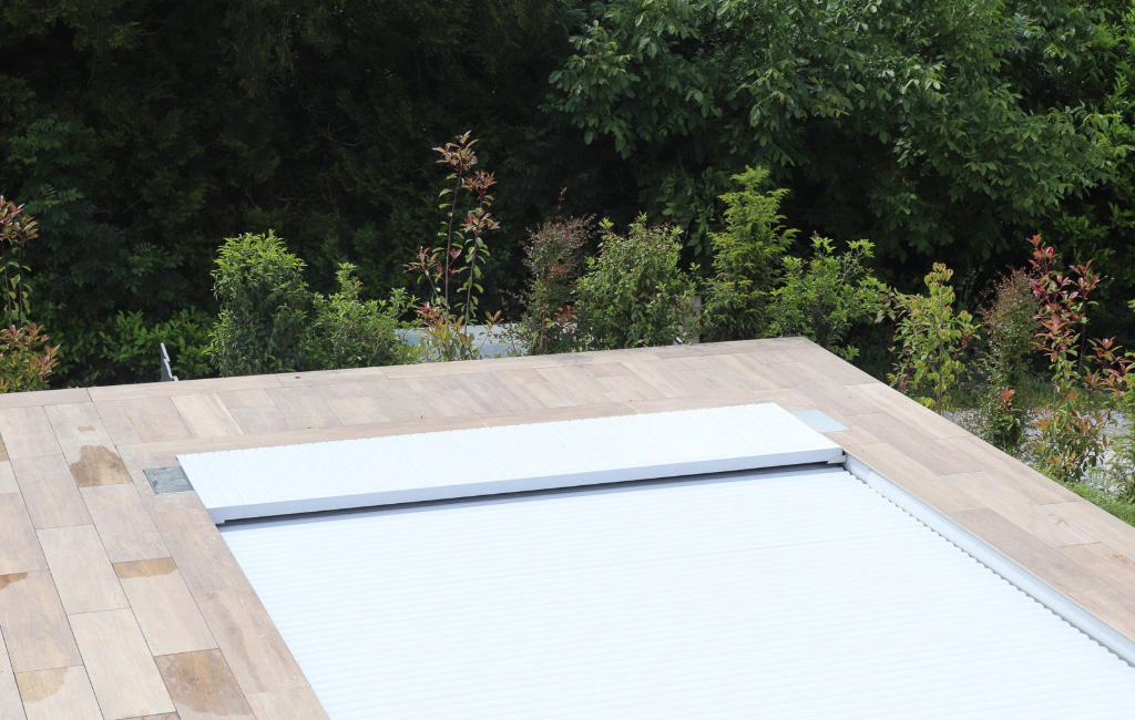terrasse-gres-cerame-imitation-bois-piscine-id jardins Terrasse en grès cérame imitation bois avec piscine dans un jardin contemporain réalisée par ID Jardins.
